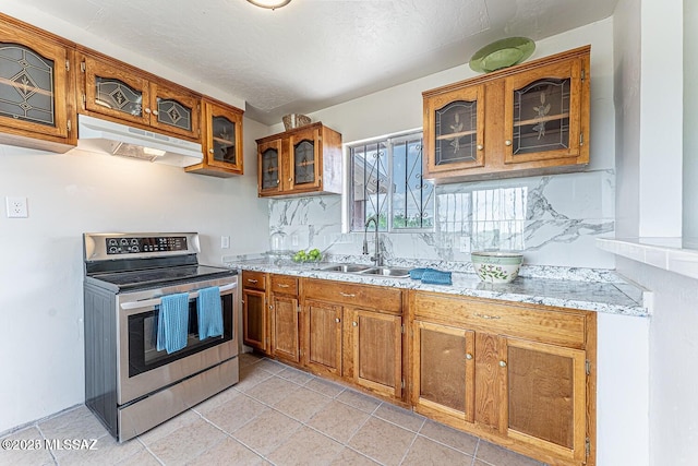 kitchen with light stone countertops, light tile patterned flooring, sink, and stainless steel electric range