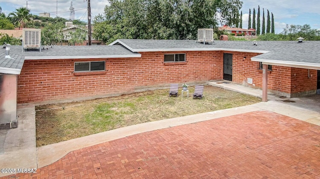 view of property exterior with a patio area and central AC