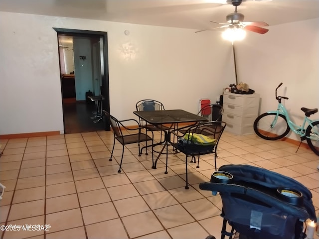 dining area featuring ceiling fan and light tile patterned floors