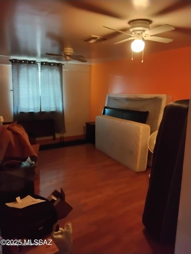 bedroom with ceiling fan and hardwood / wood-style flooring