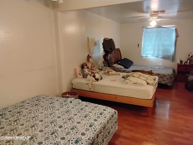 bedroom featuring ceiling fan and hardwood / wood-style flooring