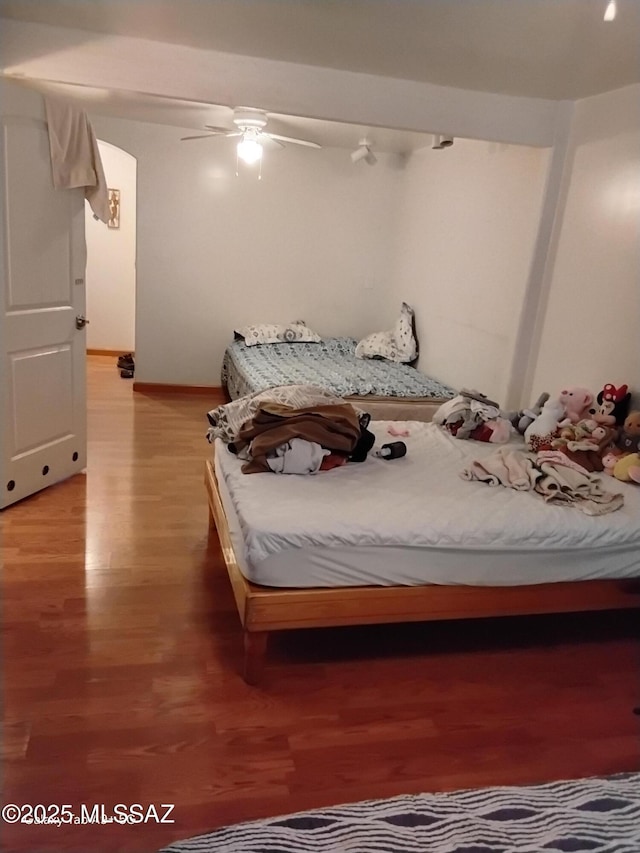 unfurnished bedroom with ceiling fan and light wood-type flooring