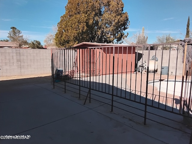 view of gate featuring a patio