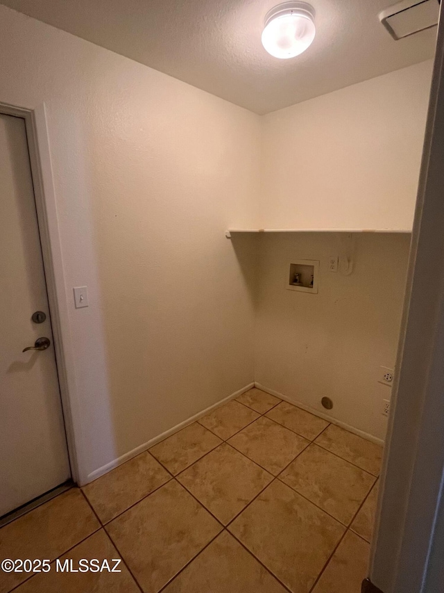 washroom with washer hookup, laundry area, and light tile patterned flooring