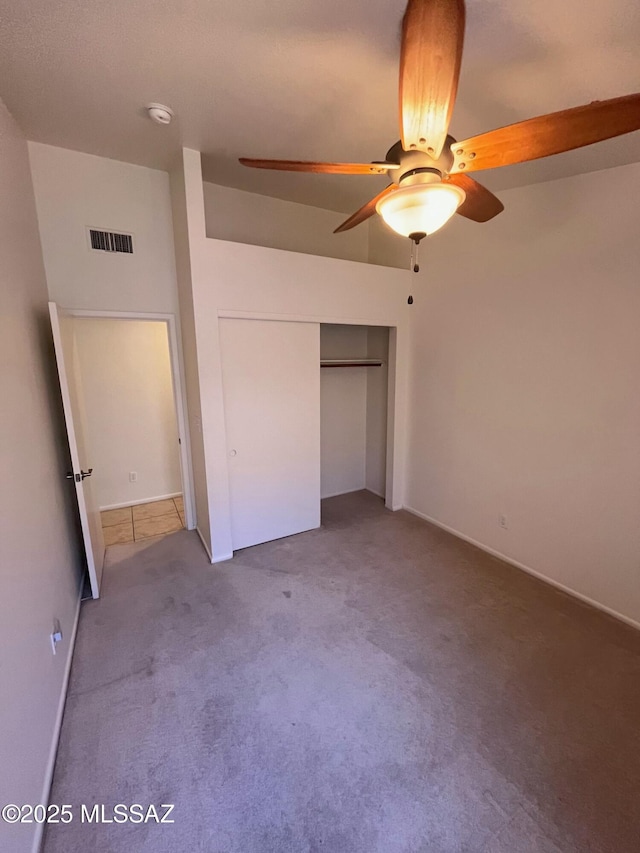 unfurnished bedroom featuring visible vents, carpet floors, a closet, and a ceiling fan