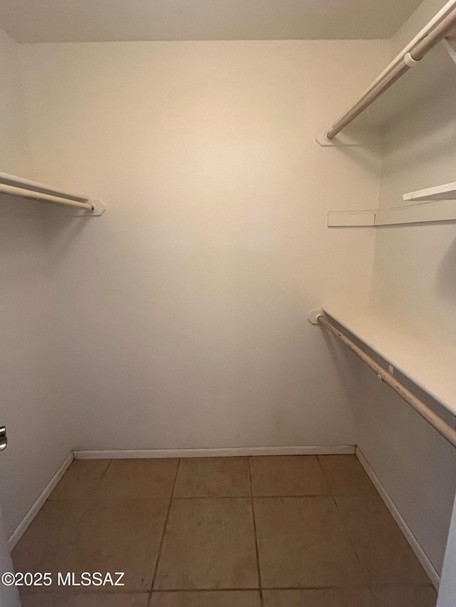 spacious closet featuring tile patterned floors