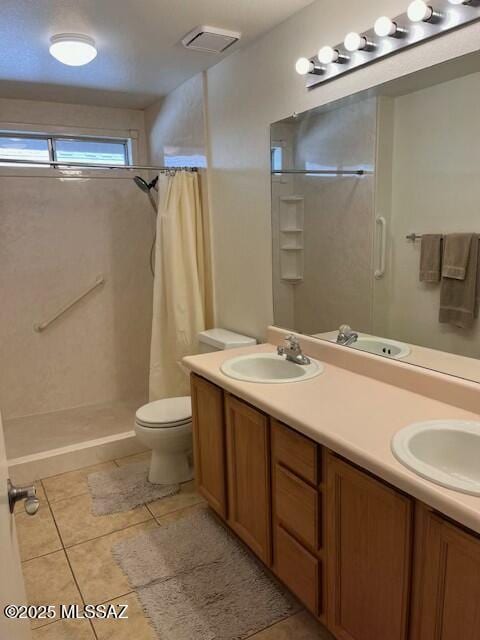 bathroom featuring double vanity, a shower with curtain, and a sink