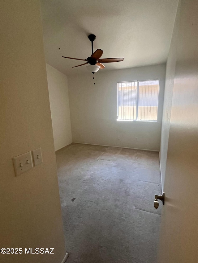 spare room featuring ceiling fan and carpet flooring