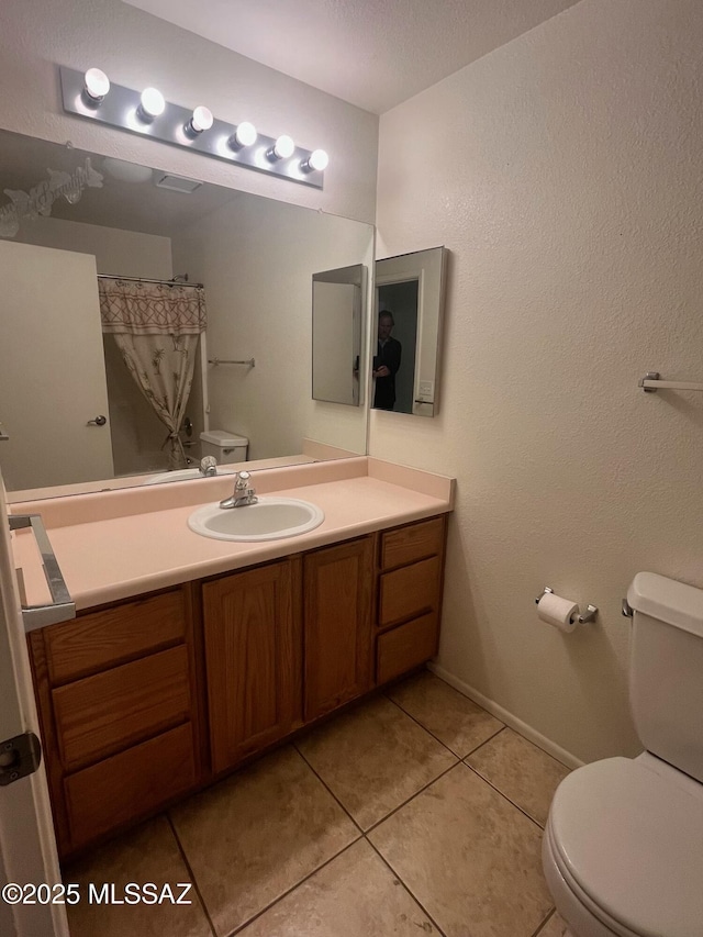 bathroom featuring toilet, tile patterned flooring, visible vents, and vanity