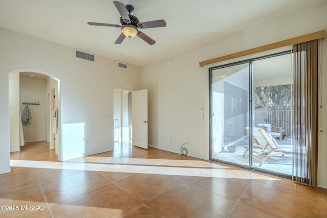 tiled empty room featuring ceiling fan