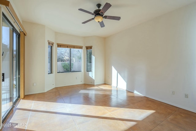 empty room with light tile patterned floors and ceiling fan