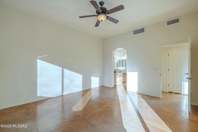 spare room with ceiling fan and light tile patterned flooring