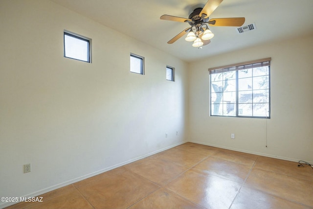 empty room with ceiling fan and light tile patterned floors