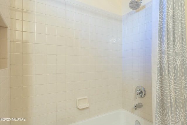 bathroom with shower / bath combo with shower curtain