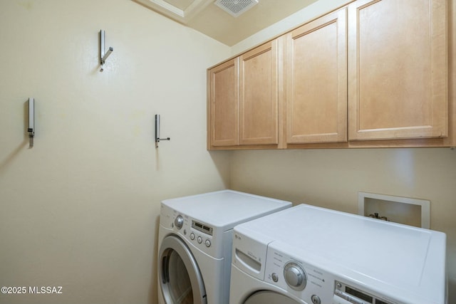 washroom featuring cabinets and washing machine and dryer