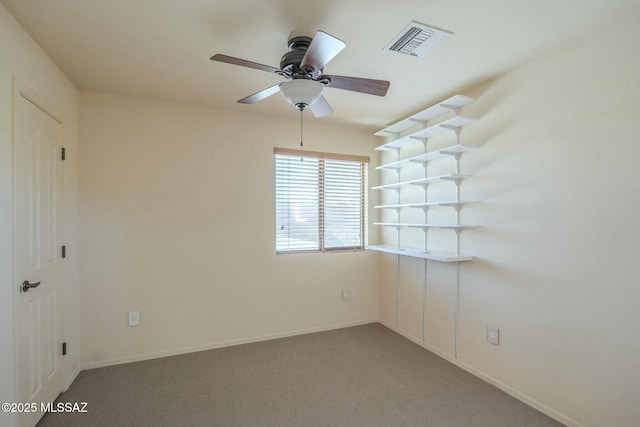 carpeted spare room with ceiling fan