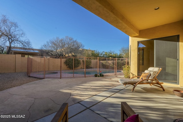 view of patio with a fenced in pool