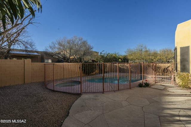 view of pool featuring an in ground hot tub and a patio area