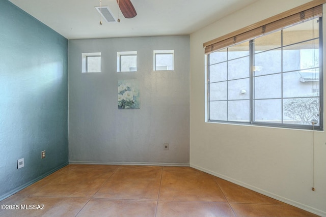 spare room featuring light tile patterned flooring and ceiling fan