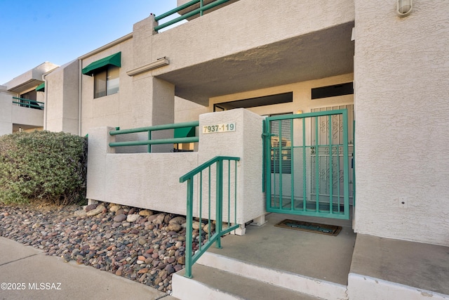 view of exterior entry with stucco siding