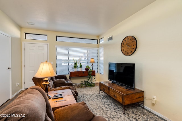 living room featuring visible vents and baseboards