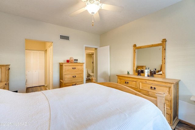 bedroom with a ceiling fan, a closet, visible vents, and wood finished floors