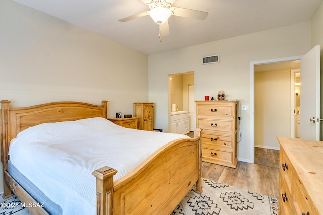 bedroom featuring light wood-type flooring, baseboards, visible vents, and a ceiling fan