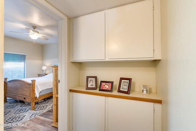 bedroom with a ceiling fan and wood finished floors