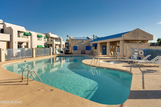 pool with a residential view, a patio area, and fence