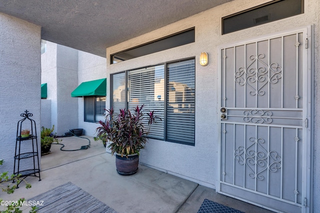 entrance to property with stucco siding