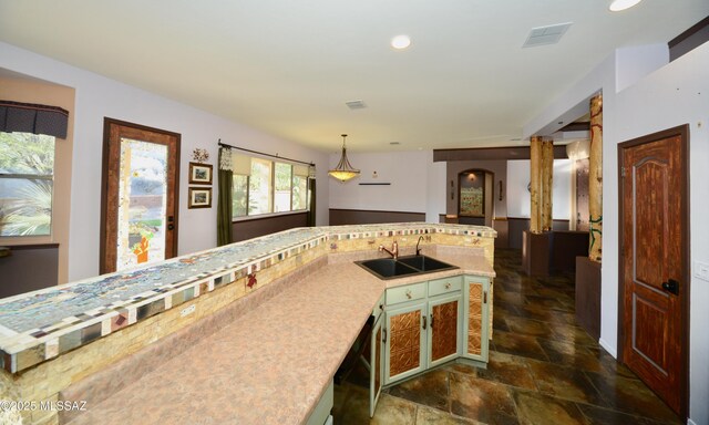 kitchen with decorative light fixtures and sink