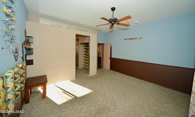 spare room featuring ceiling fan and carpet