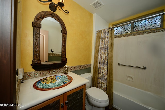 full bathroom featuring toilet, vanity, and shower / tub combo