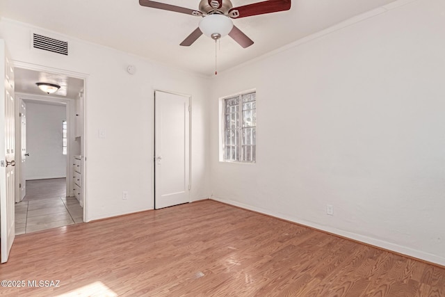 unfurnished bedroom with multiple windows, a closet, ceiling fan, and light hardwood / wood-style floors