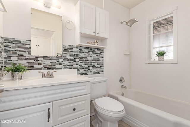 full bathroom with decorative backsplash, shower / washtub combination, toilet, and vanity