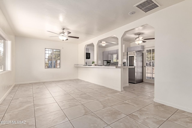 interior space featuring ceiling fan and light tile patterned flooring