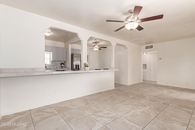 tiled spare room with ceiling fan