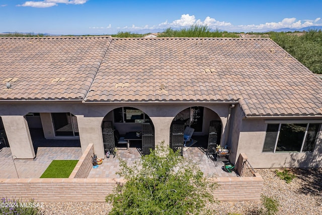 rear view of property featuring a patio