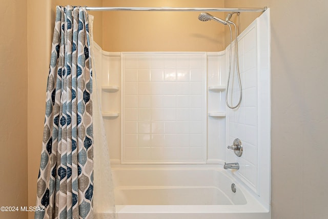 bathroom with shower / bath combo with shower curtain