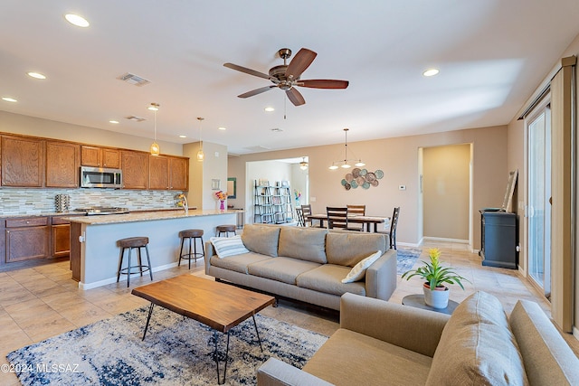 tiled living room featuring ceiling fan