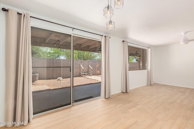 unfurnished room featuring ceiling fan, a healthy amount of sunlight, and light wood-type flooring