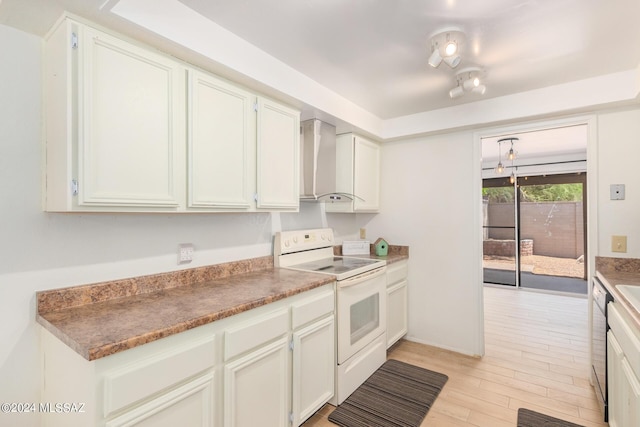 kitchen with white cabinetry, wall chimney exhaust hood, and white range with electric stovetop