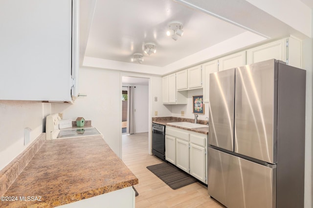 kitchen featuring dishwasher, sink, white cabinets, stainless steel fridge, and stove