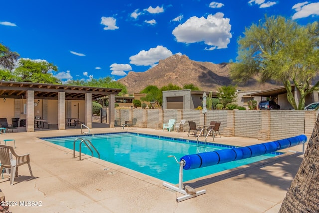 view of pool featuring a mountain view and a patio