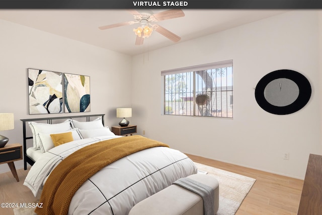 bedroom with light hardwood / wood-style flooring and ceiling fan