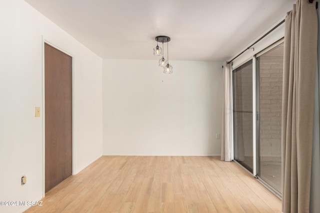 empty room with light hardwood / wood-style flooring