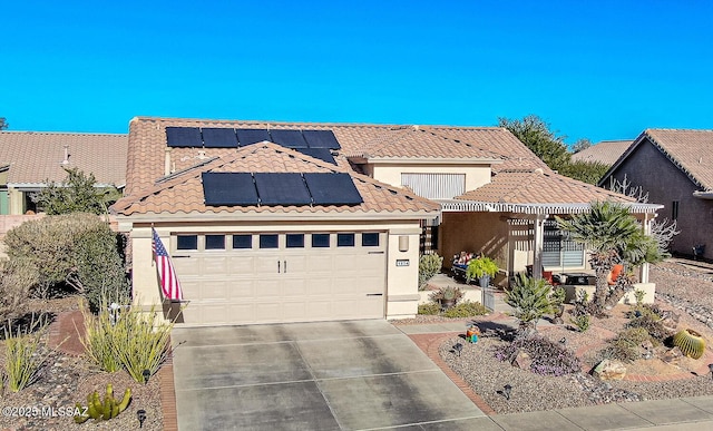 view of front facade with a garage and solar panels