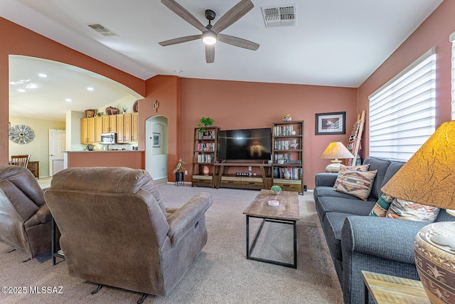 living room featuring ceiling fan, lofted ceiling, and carpet