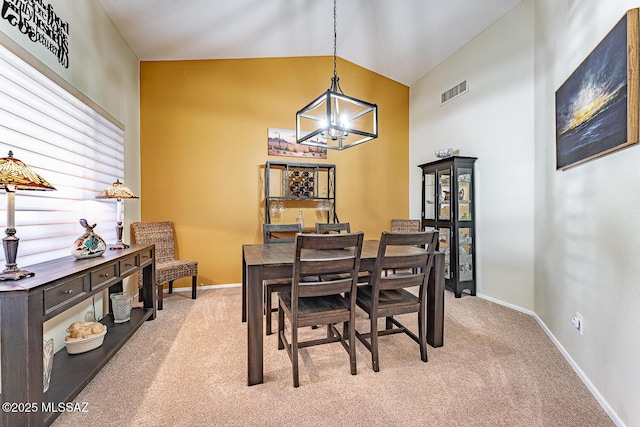 dining space with vaulted ceiling, light carpet, and a notable chandelier