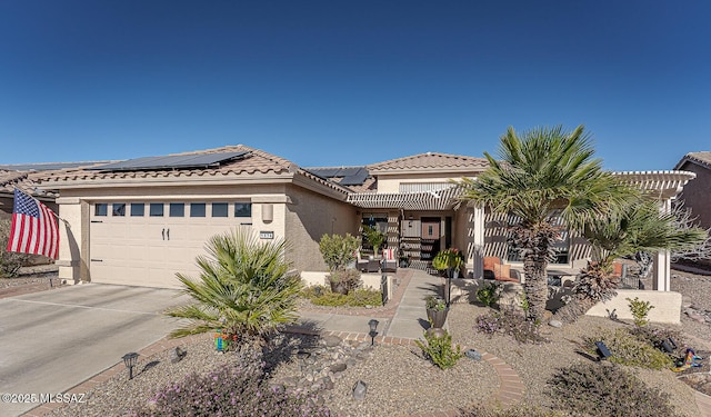 view of front of home with a garage and solar panels